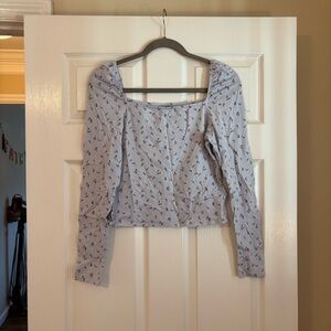 Baby blue floral blouse with sinched shoulders.